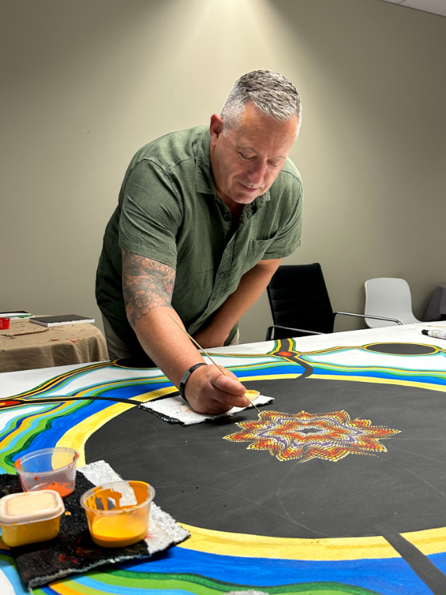 Man drawing on black canvas