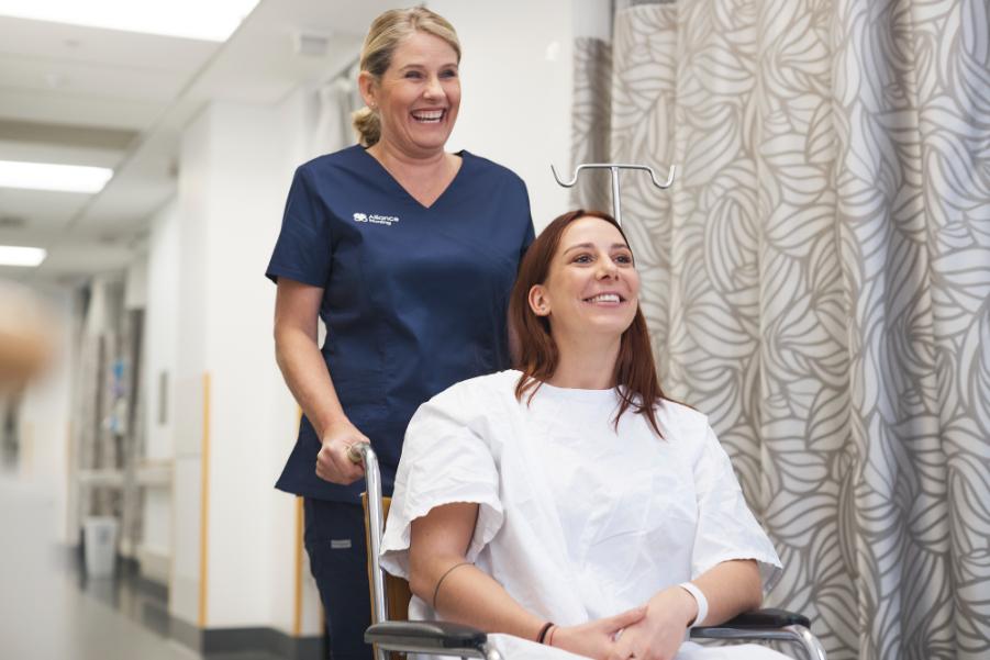 Nurse pushing patient in wheelchair