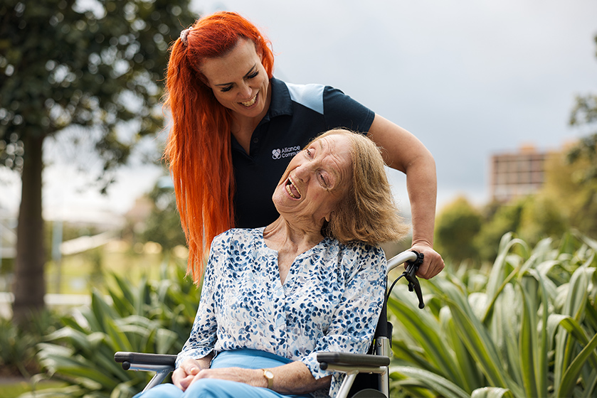 Elder lady being helped by support walker